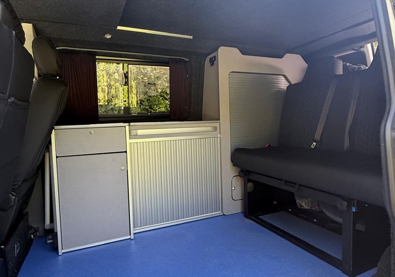Cuddy interior showing kitchen units and blue floor