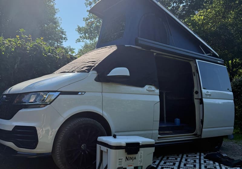 Cuddy with sliding side door open and pop-top raised