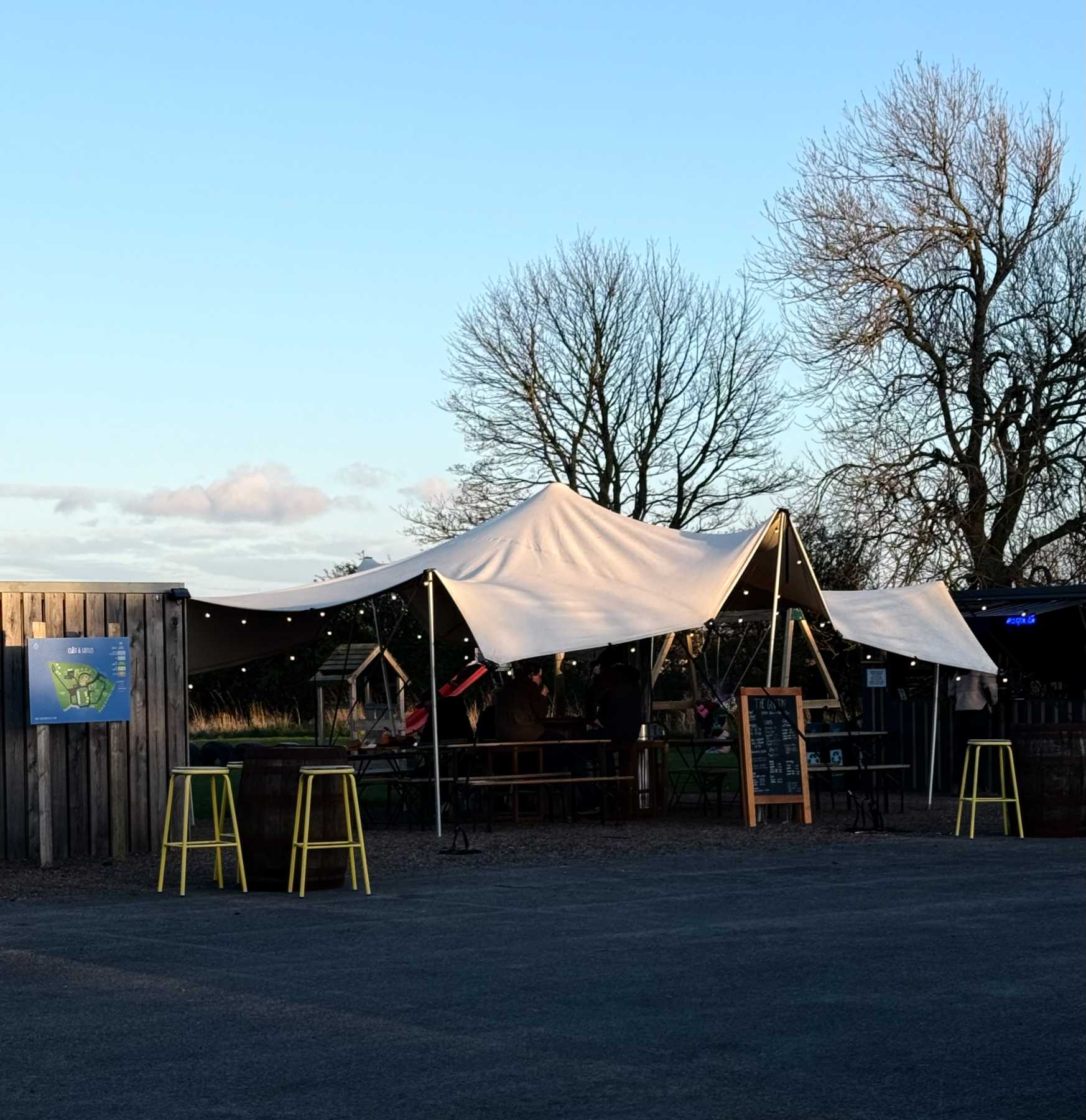 The Gin Tin bar with stretch tent and outdoor seating at Coast and Castles